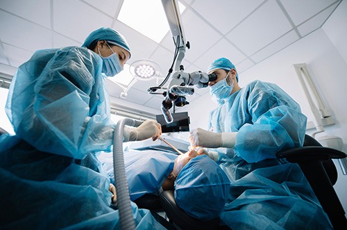 Dentists performing a dental implant surgery
