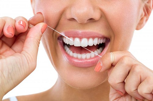 Lady flosses teeth