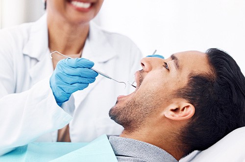 Profile view of man undergoing dental exam