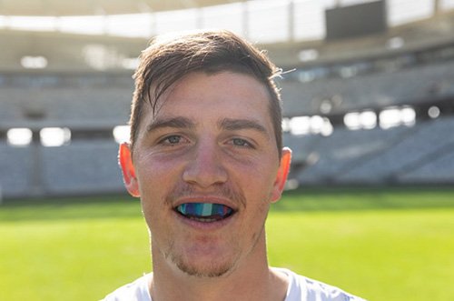 Man wears athletic mouthguard