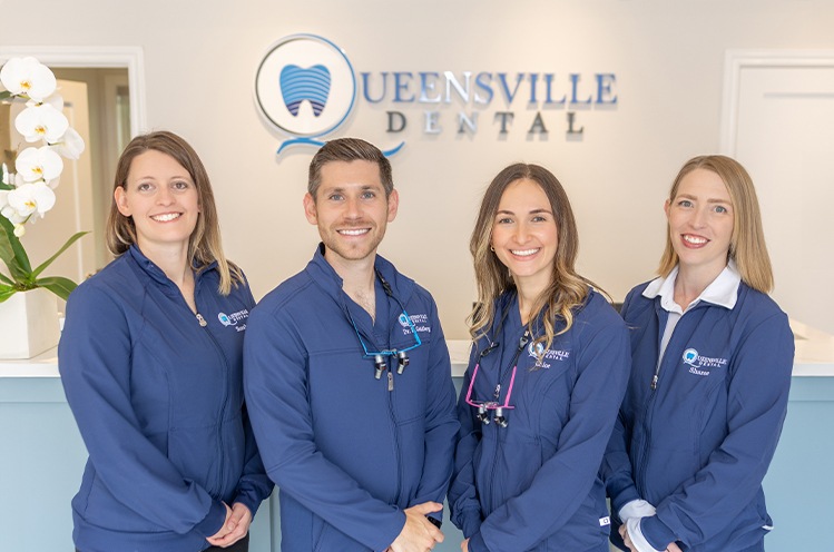 Woman in dental chair giving thumbs up