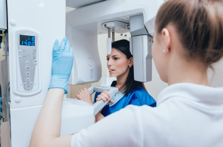 Woman receiving 3 D C T cone beam digital x-ray scans