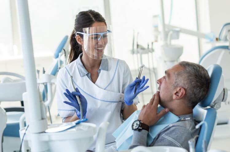 Dentist discussing comprehensive dental care with dental patient