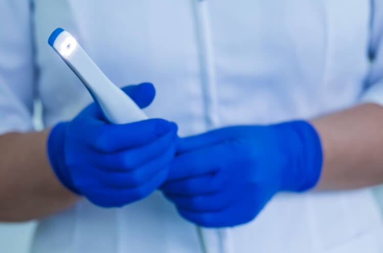 Dentist holding intraoral camera
