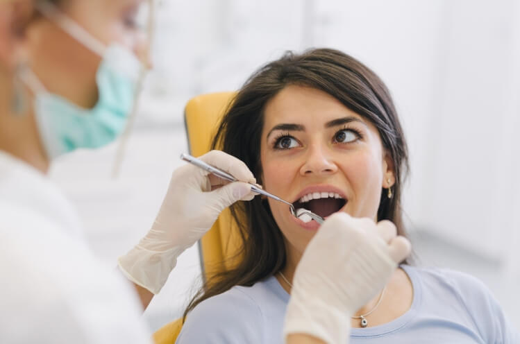 Woman receiving tooth canal therapy