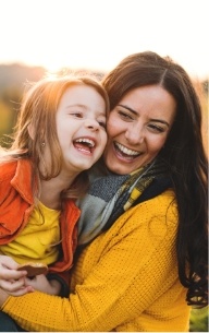 Mother and child laughing after children's dentistry visit