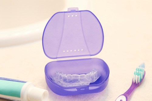 Clear aligners in a purple case