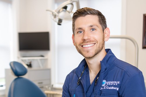 a dentist showing a patient their Invisalign aligners