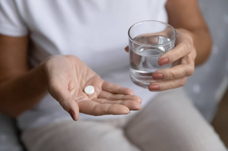 Person taking an antibiotic pill