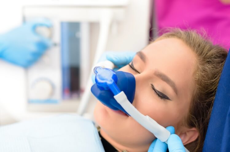Dental patient receiving treatment under nitrous oxide dental sedation