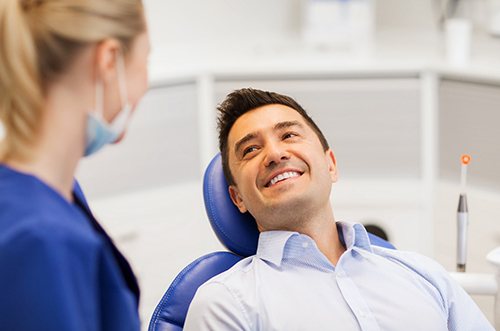 man talking with dentist for teeth whitening in East Gwillimbury